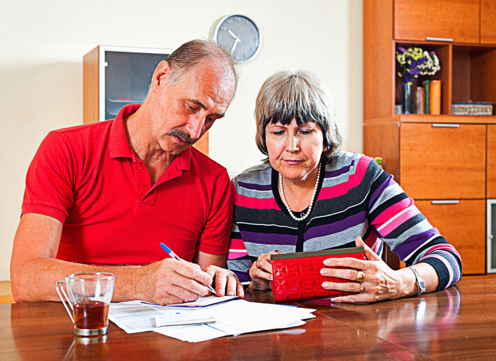 sad senior couple-calculating budget