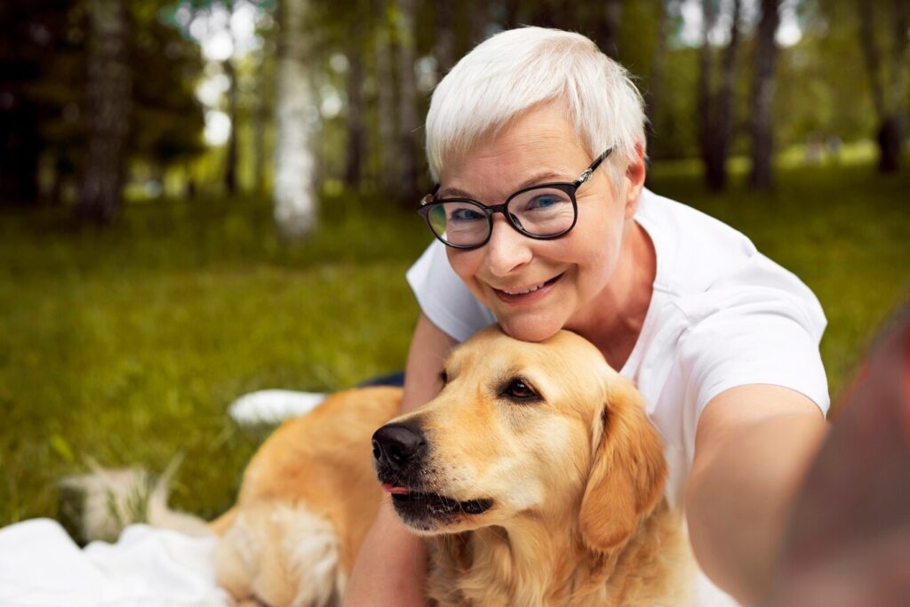 portrait older person-taking selfie with their dog