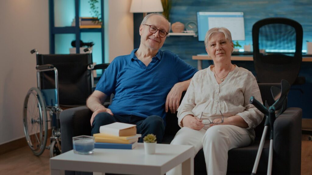 retired-couple-with-disability-sitting-couch